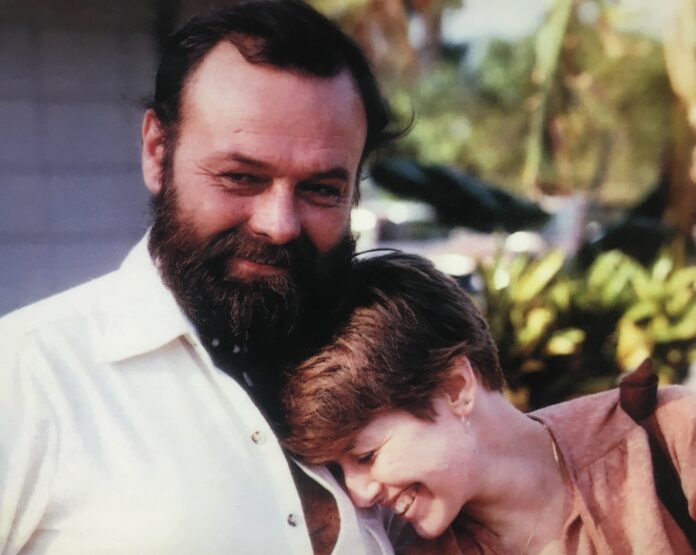 Phil and Carol a man with a beard is holding a young boy