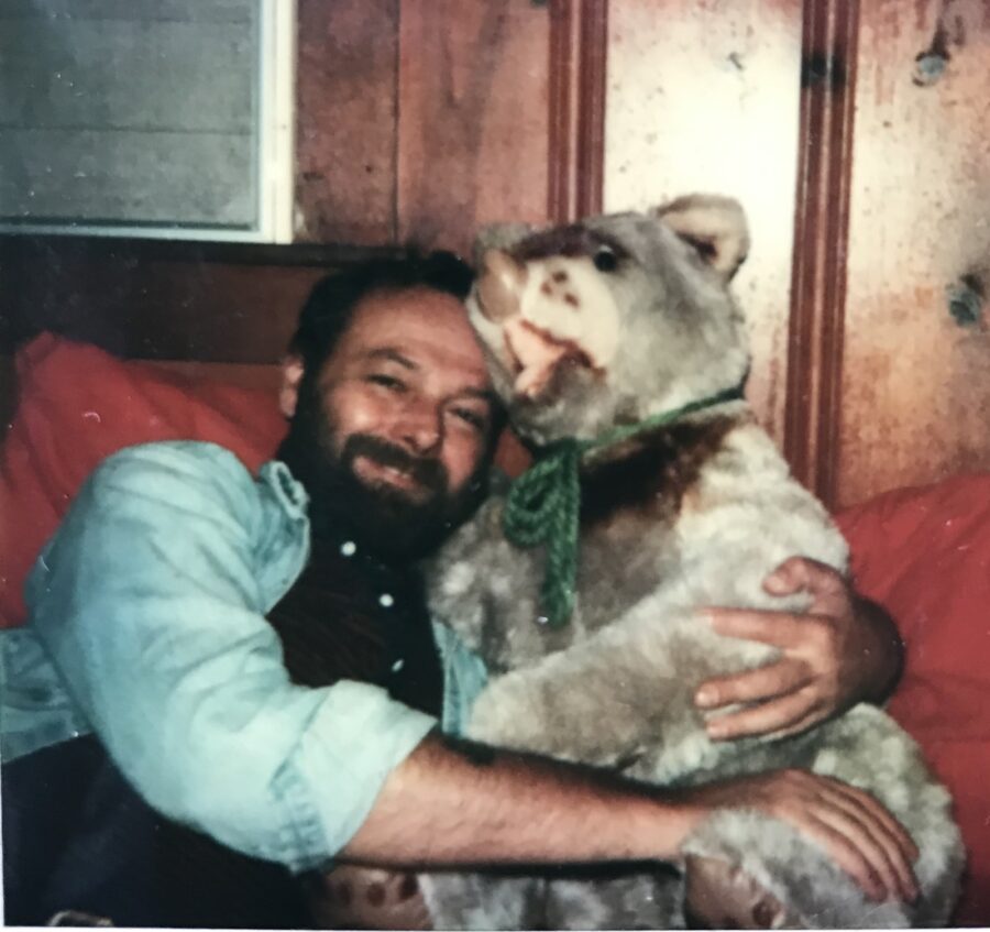 a man holding a dog in his arms