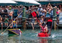 a group of people riding paddle boats on top of a body of water