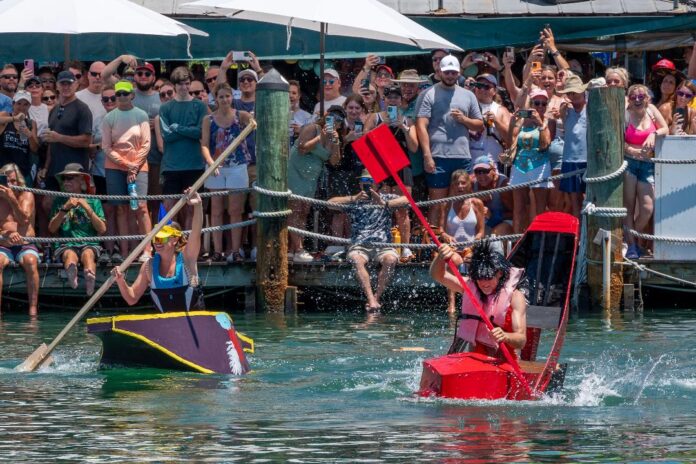 a group of people riding paddle boats on top of a body of water
