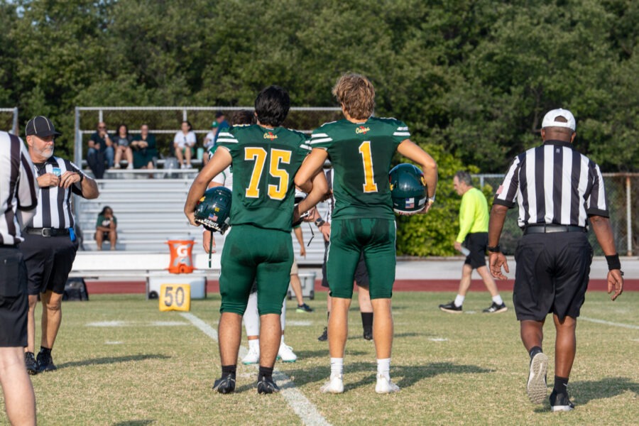 a group of football players standing on top of a field