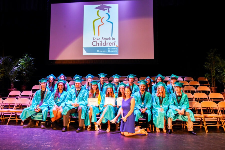 a group of graduates sitting on a stage