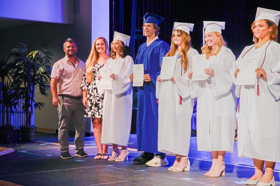 a group of people standing on top of a stage