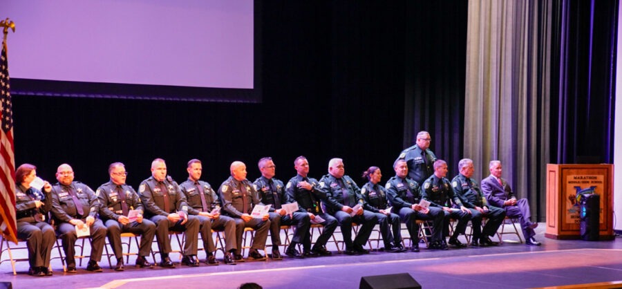 a group of military men sitting on a stage