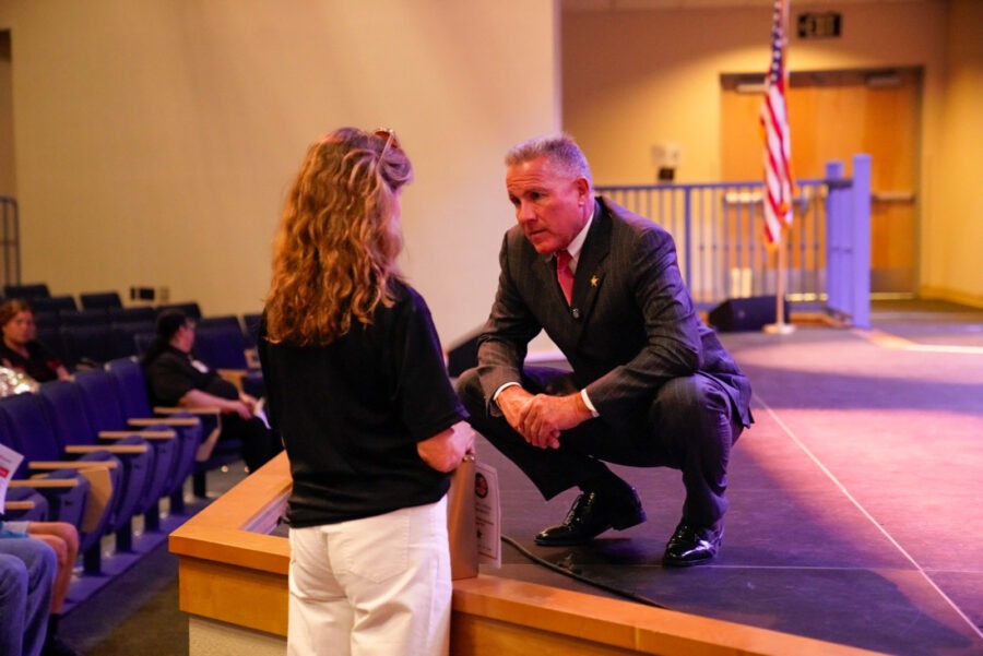 a man and a woman sitting on a stage