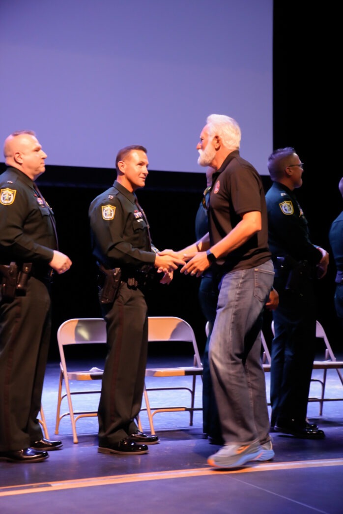 a group of men standing on top of a stage