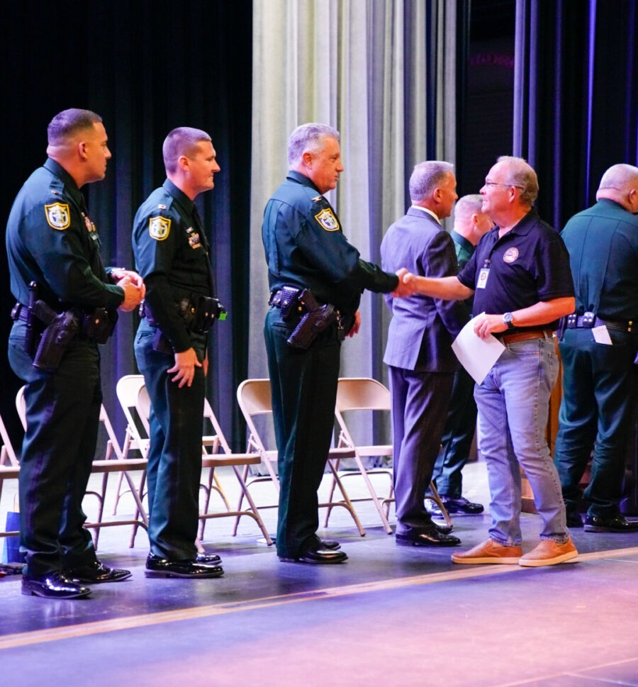 a group of men standing next to each other on a stage