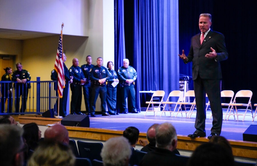 a man standing on a stage in front of a crowd of people