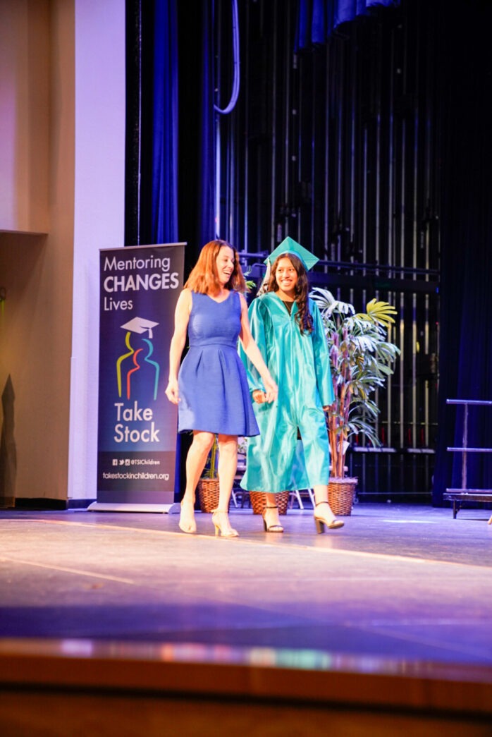 a couple of women standing on top of a stage