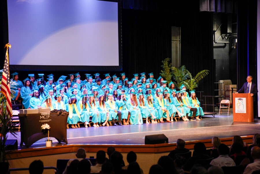 a group of people standing on a stage in front of a crowd