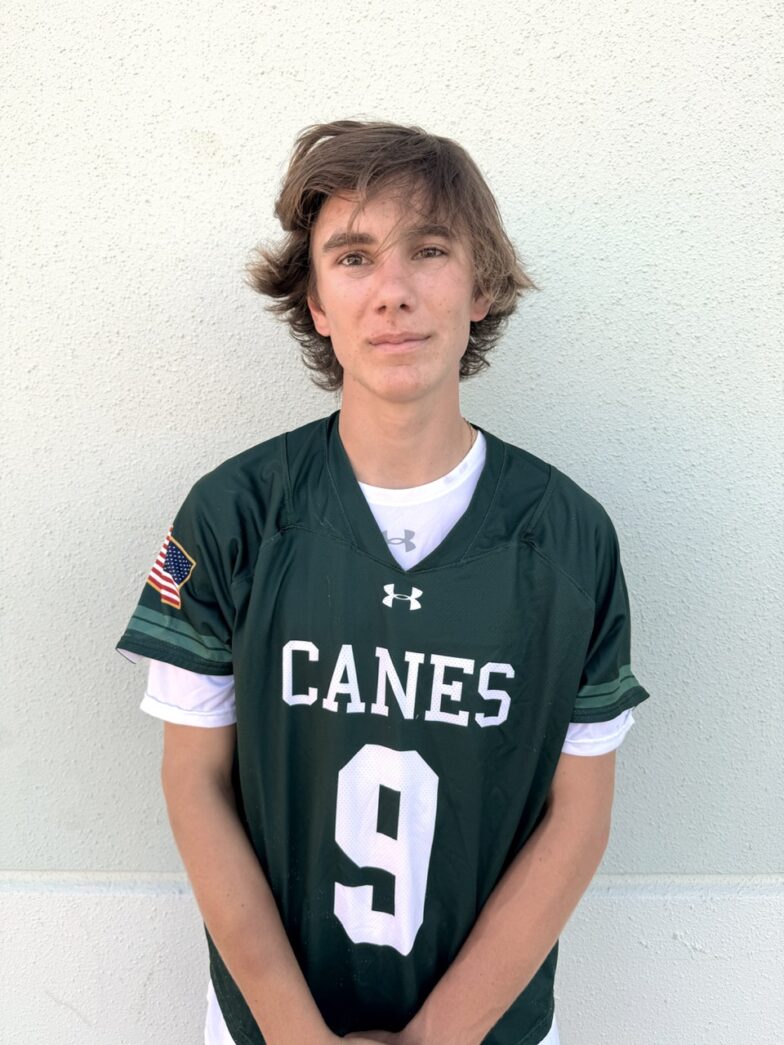 a young man in a football uniform poses for a picture