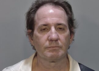 a mug shot of a man in a white shirt
