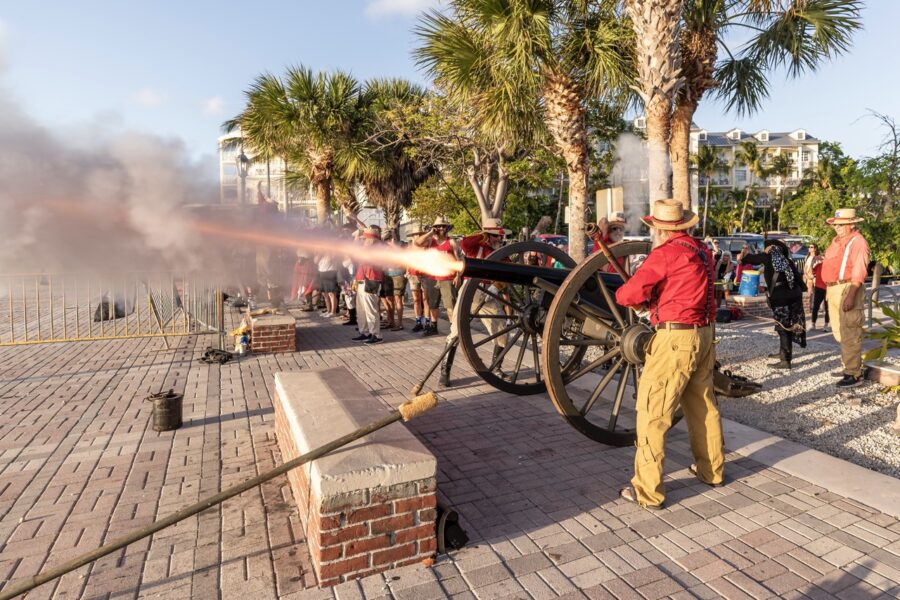 a group of people standing around a cannon