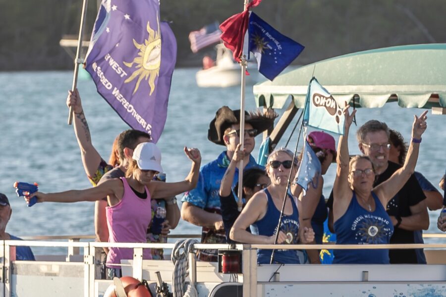 a group of people on a boat waving flags