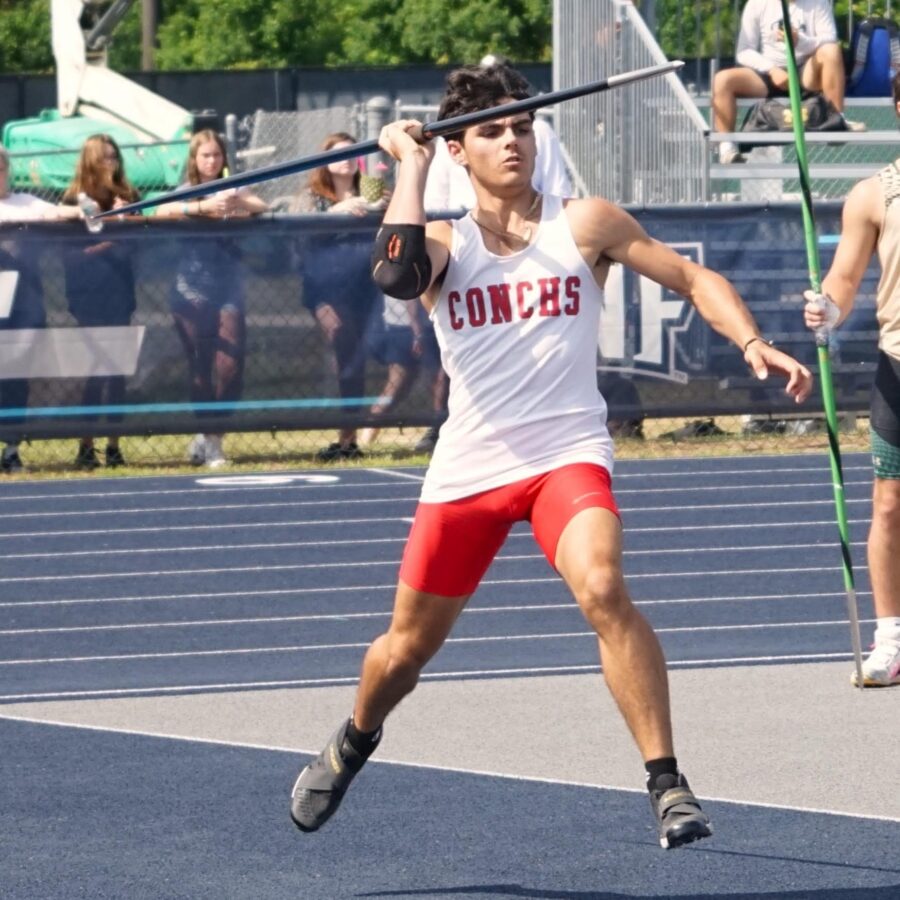 a man holding a baseball bat on top of a tennis court