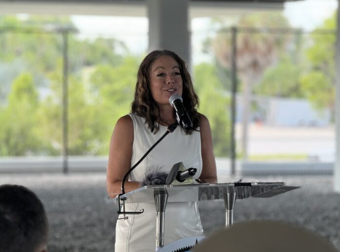 Shannon Weiner 1 a woman standing at a podium with a microphone