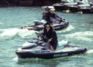 a couple of people riding jet skis on top of a body of water