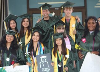 a group of people in graduation gowns posing for a picture