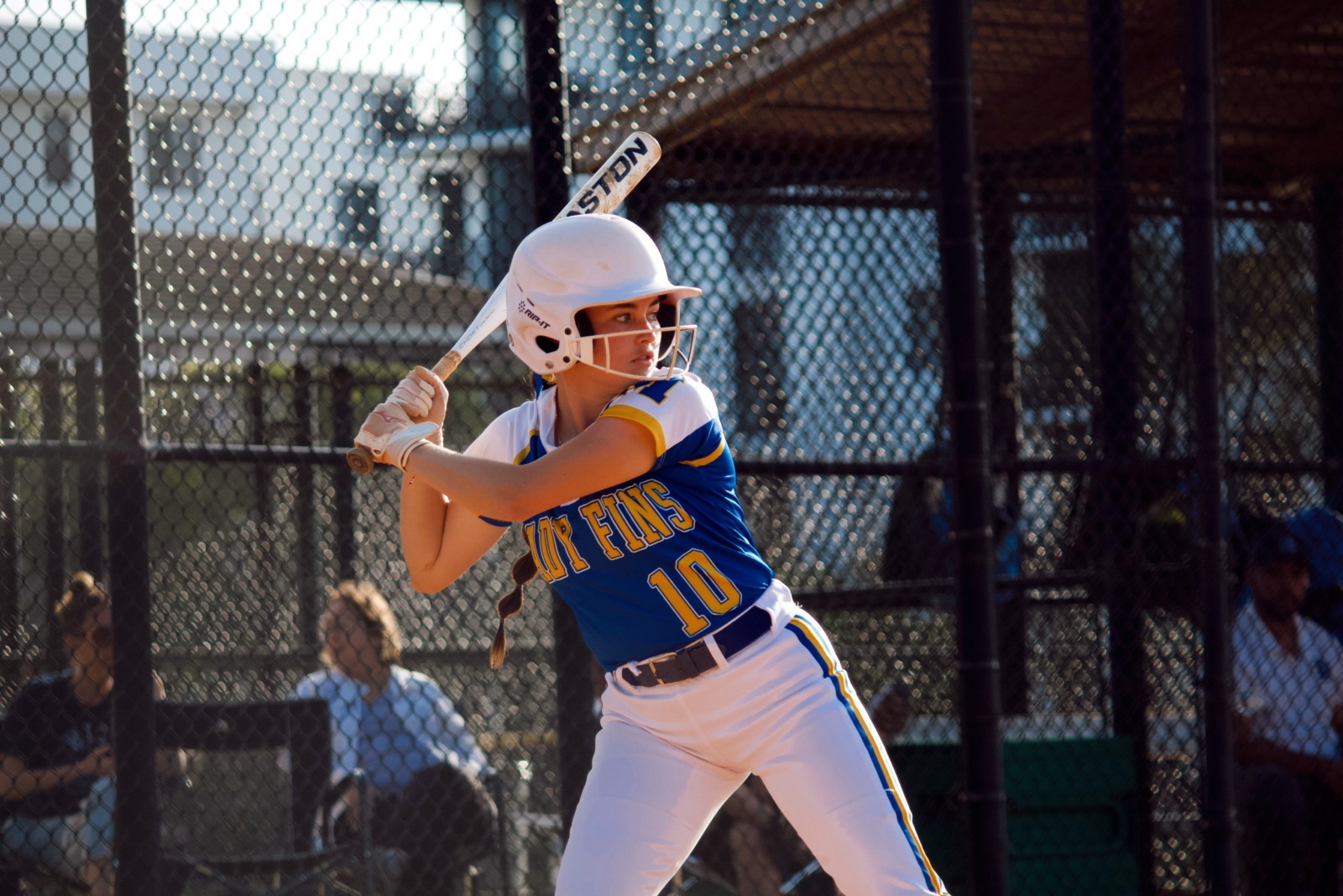 a baseball player holding a bat on top of a field