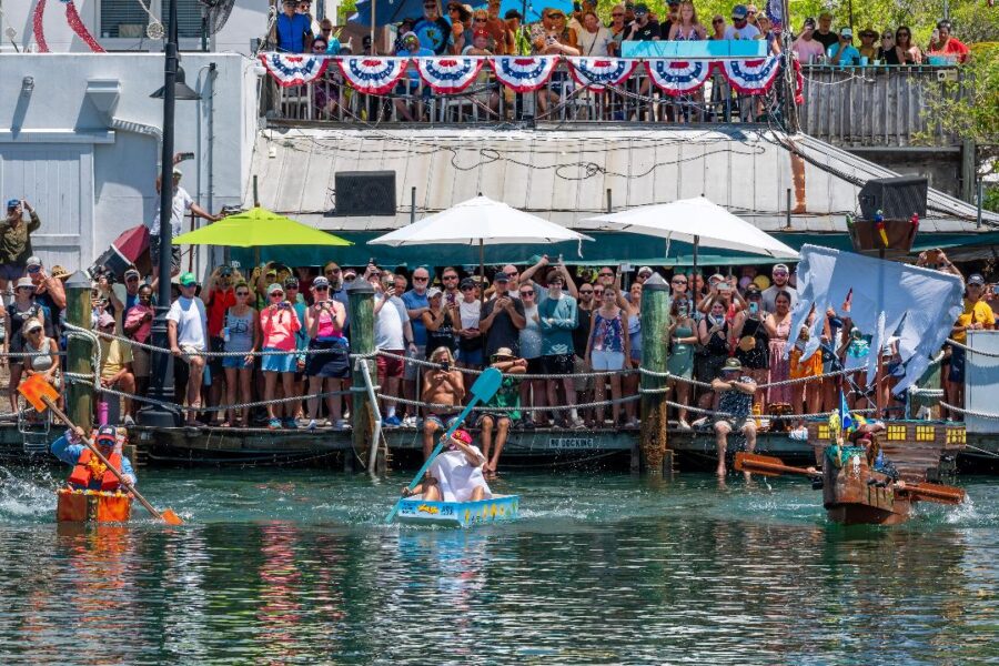 a group of people riding paddle boats down a river