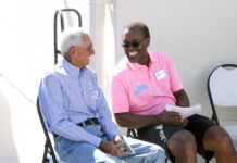 a couple of men sitting next to each other