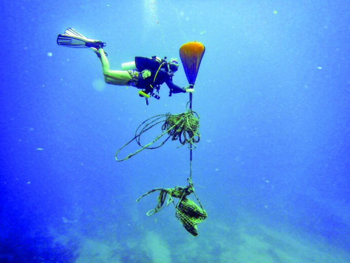 Trash derby 1 a person diving in the ocean with a parachute