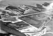 a black and white photo of an aerial view of a bridge