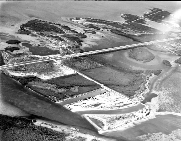 a black and white photo of an aerial view of a bridge