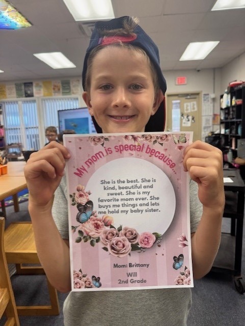 a young girl holding up a card with a poem on it