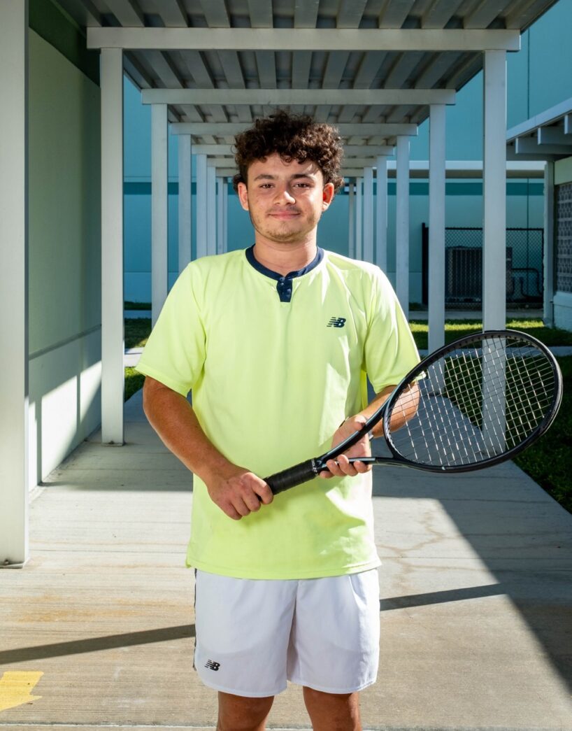a man holding a tennis racquet on a tennis court