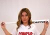a woman in a baseball uniform holding a bat