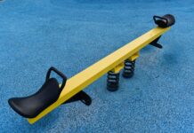 a yellow and black bench on a blue carpet