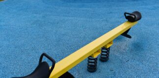 a yellow and black bench on a blue carpet