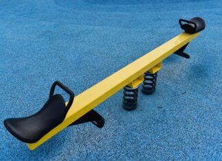a yellow and black bench on a blue carpet
