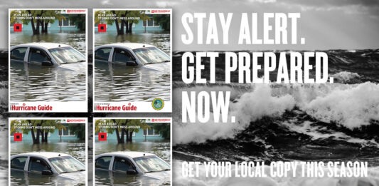 a black and white photo of a car submerged in water