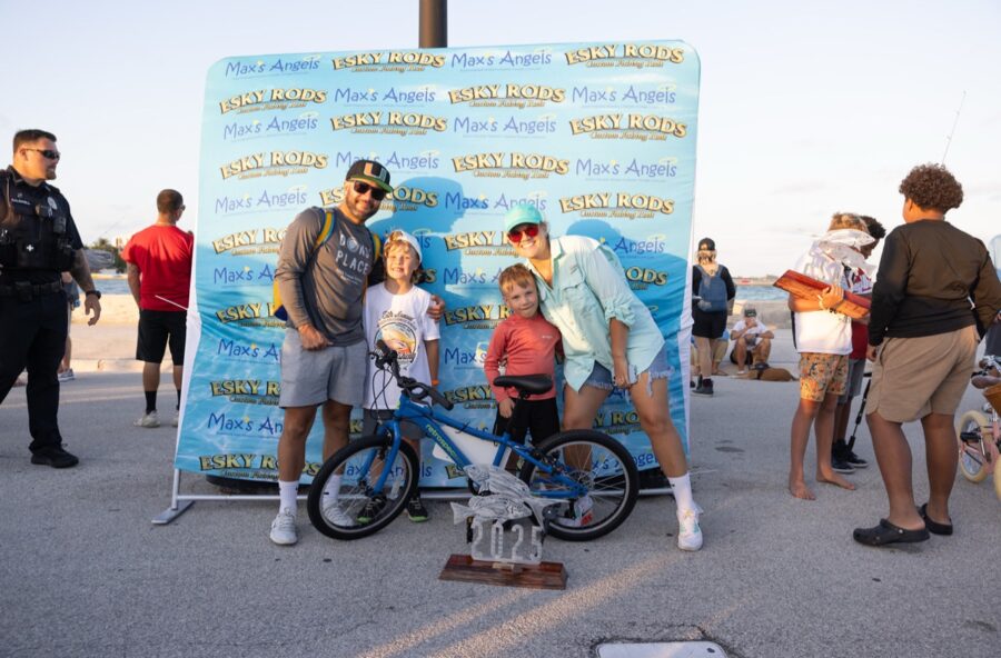 a group of people standing around a bike
