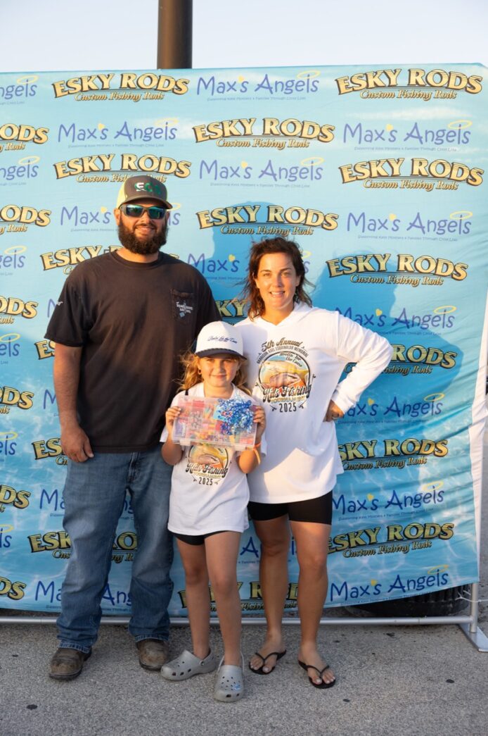 a man and a woman standing next to a little girl