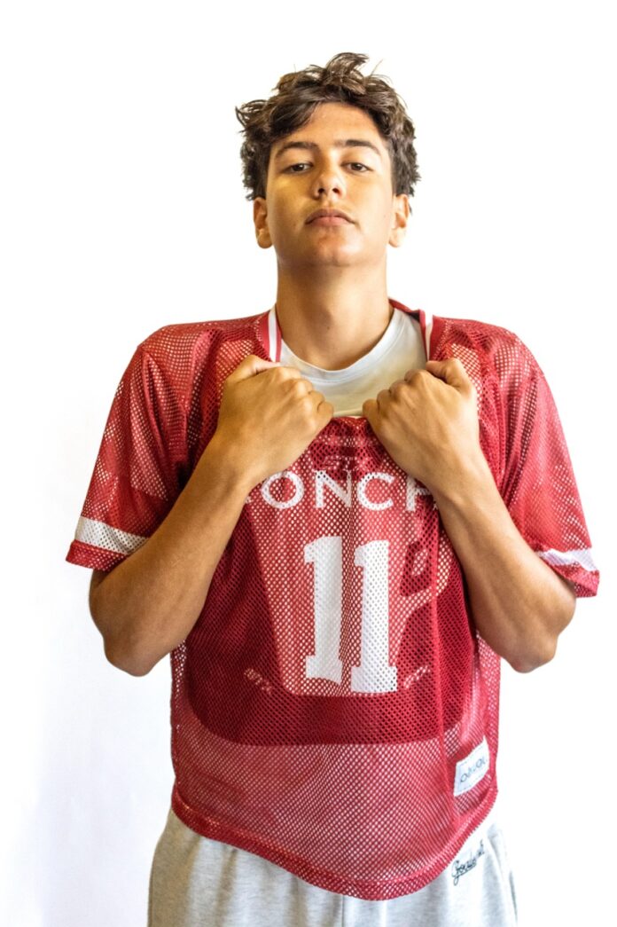a young man in a football uniform is posing for a picture