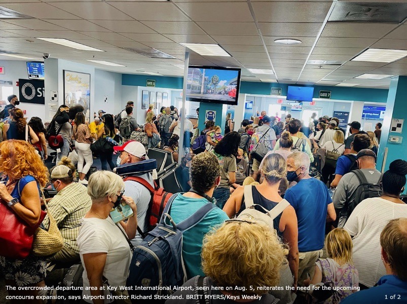 a large group of people standing in an airport