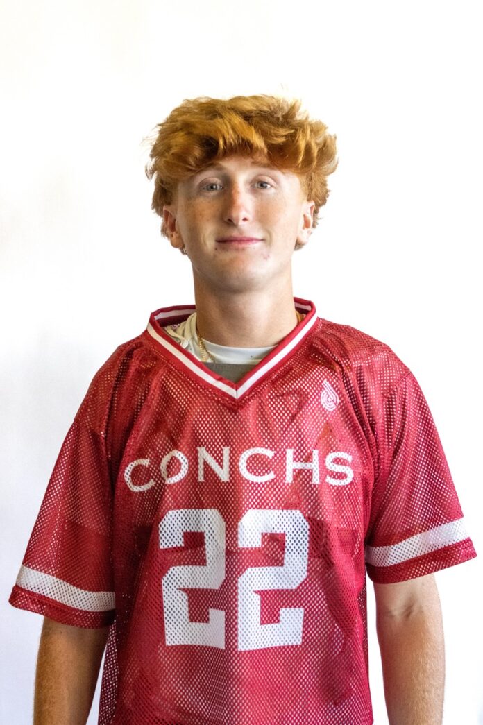 a young man in a football uniform posing for a picture