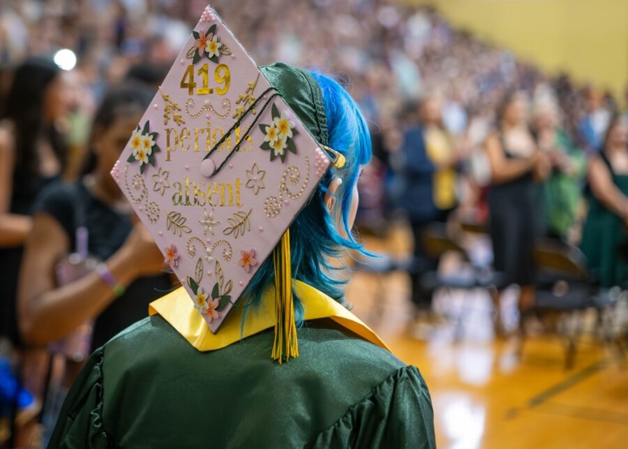 a person wearing a graduation cap with flowers on it