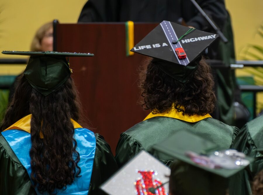 a group of people in graduation gowns and hats