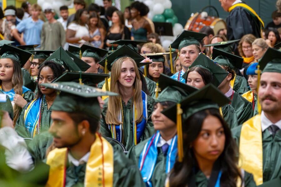 a large group of people in graduation caps and gowns