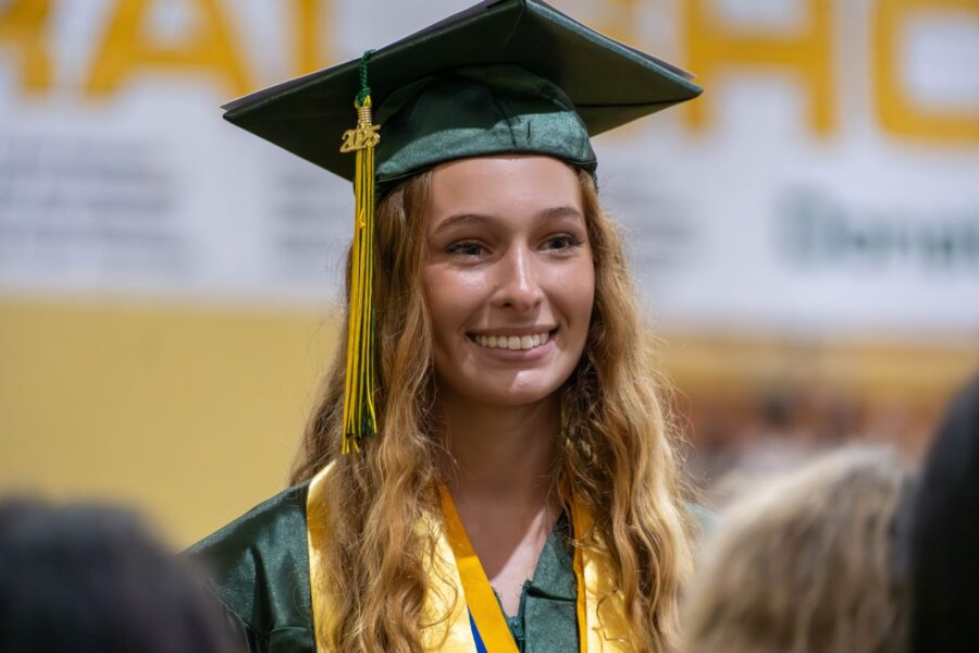 a woman in a graduation cap and gown