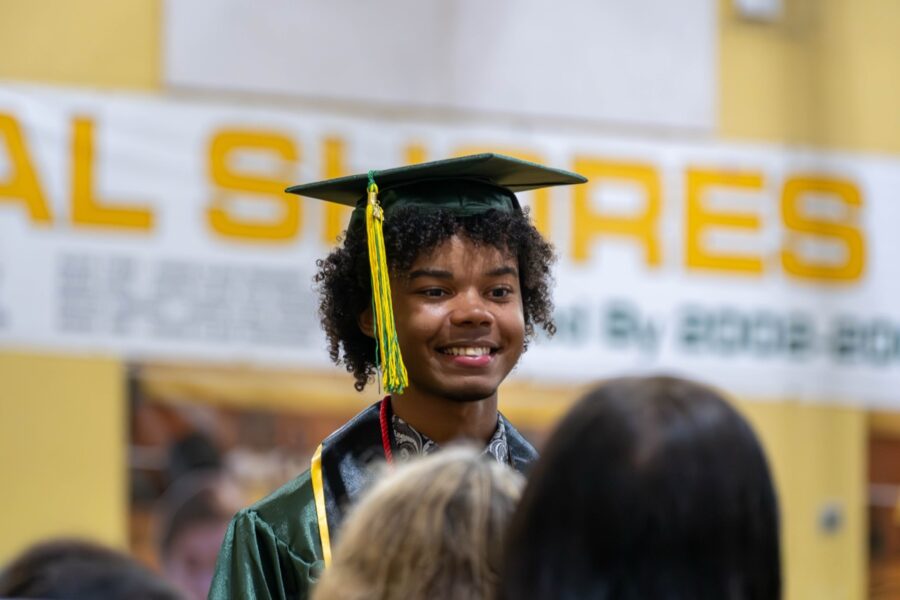 a young man in a graduation cap and gown