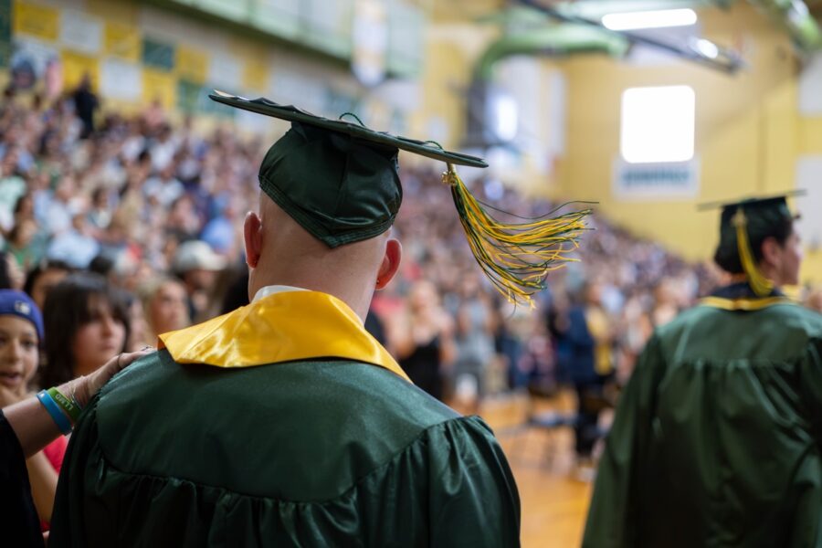 a group of people in graduation gowns and caps