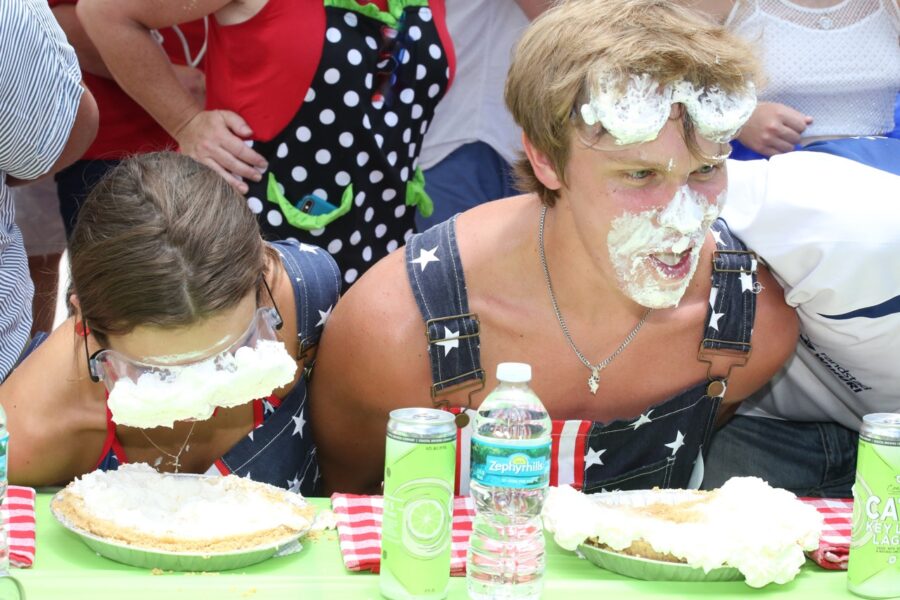 a group of people with cake on their faces