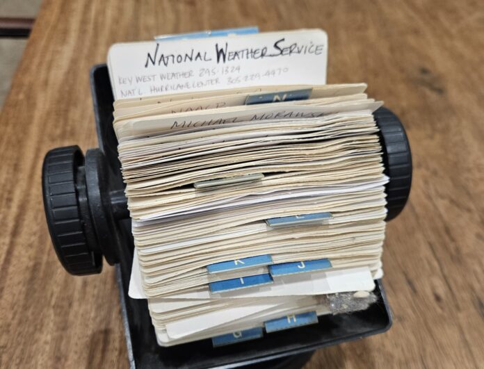 a stack of mail sitting on top of a wooden table