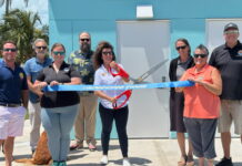 a group of people holding a large blue ribbon