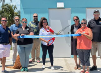 a group of people holding a large blue ribbon